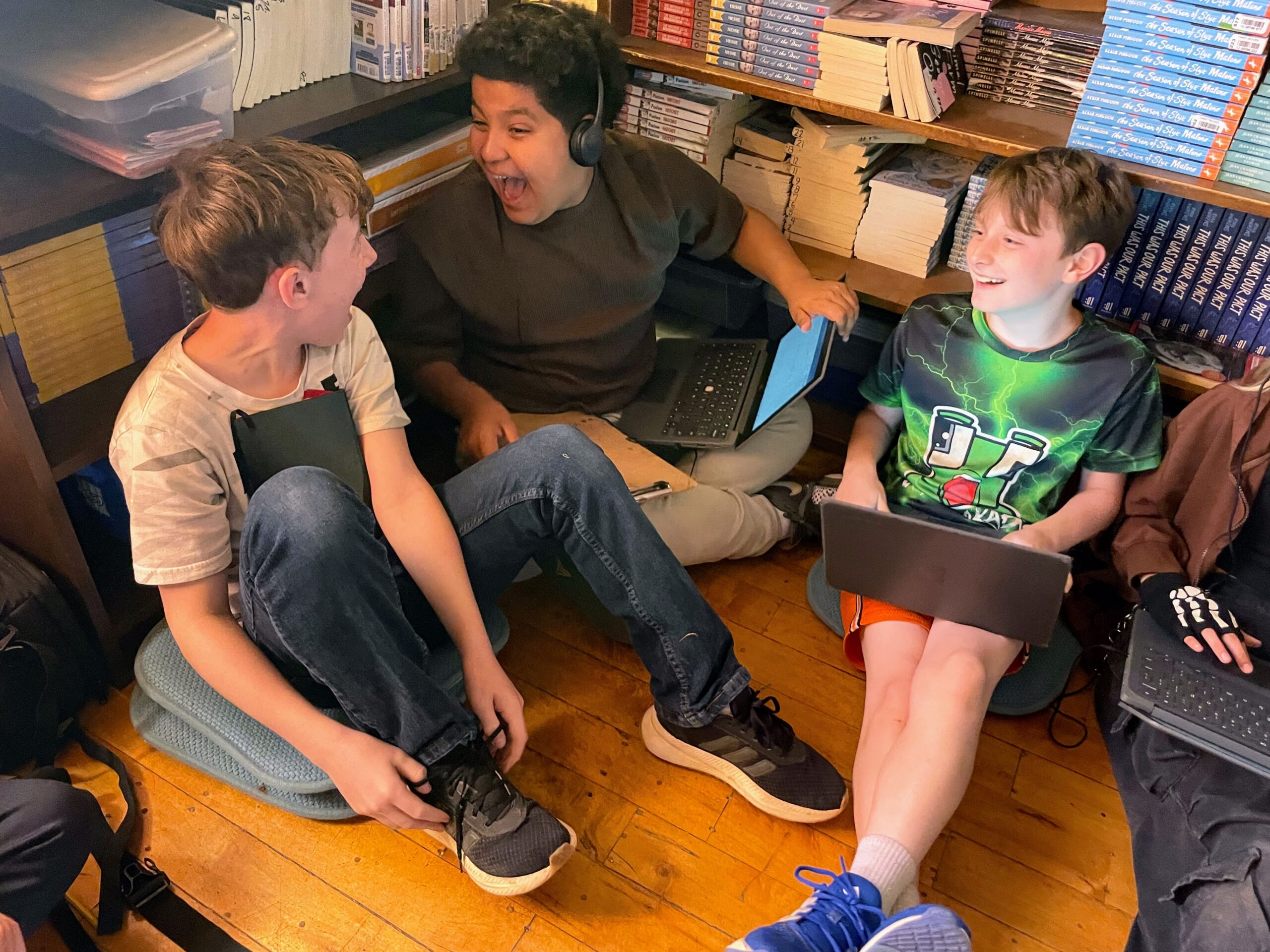 Hawbridge students collaborating with digital devices and headphones